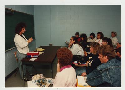 Students listen to a female student giving a presentation
