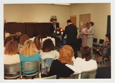 A group of people listen and watch during a workshop on grief