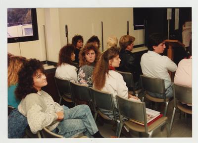 A group of people listen and watch during a workshop on grief