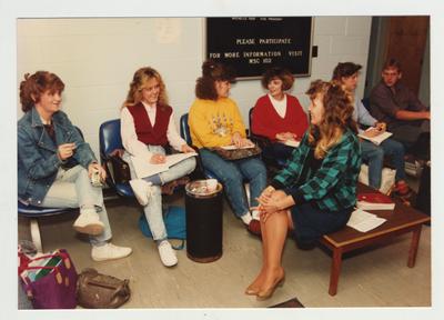 Students sit and converse in a lobby