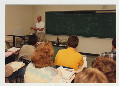 Students listen to a male professor during a Chemistry lecture