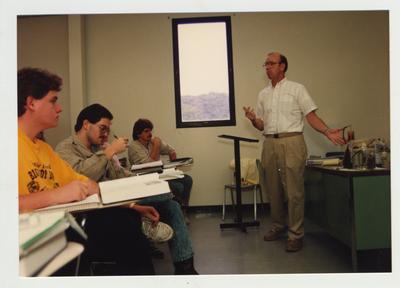 Students listen to a male professor during a Chemistry lecture
