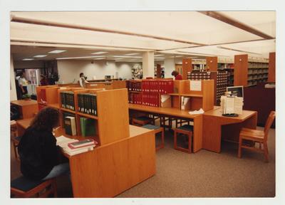Students stand in the library