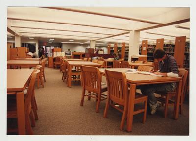 Students stand in the library