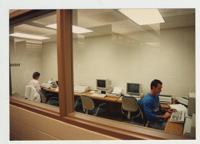 Students type on a computer in the computer lab located in the library