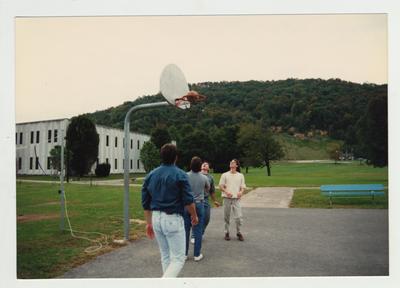 Male students play basketball