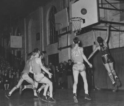 Basketball game action, UK versus Tennessee; Marvin Akers (13) scores; photo appears on page 198 in the 1941 Kentuckian