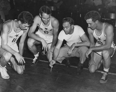 East All-Star basketball team members (high school players participating in a UK coaching clinic); pictured left to right are Tim Sullivan, Dayton, Tom Lyons, Mt. Sterling, coach Bobby Laughlin, Morehead, and Kenny Reeves, Maysville; photo received June 13, 1959 from the Cincinnati Enquirer