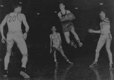 Basketball game action, UK versus Tennessee. Pictured is Ralph Beard taking a shot; photo appears on page 195 in the 1948 Kentuckian