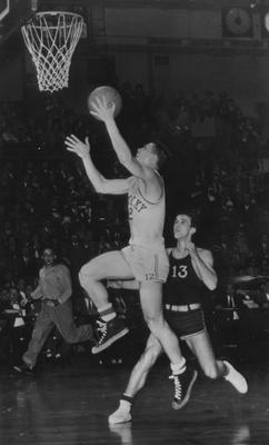 Basketball team member Ralph Beard pictured taking a shot at the UK vs. University of Louisville Olympic trial game at Madison Square Garden, New York; UK won the game 91-57 and moved to the semifinals; photo received June 13, 1959 from the Cincinnati Enquirer