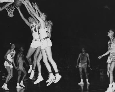 Basketball game action, UK versus Florida State; Don Mills (52) watches as Lowell Hughes (44) and Bobby Slusher (32) go for a rebound