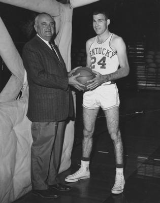 Team member Johnny Cox (24) standing with coach Adolph Rupp