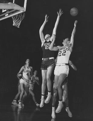 Basketball game action, UK versus Ole Miss; Ned Jennings (4) and Jim McDonald (20) watch as Sid Cohen (22) shoots; photographer:  Ken Kuhn (University of Kentucky sports information)