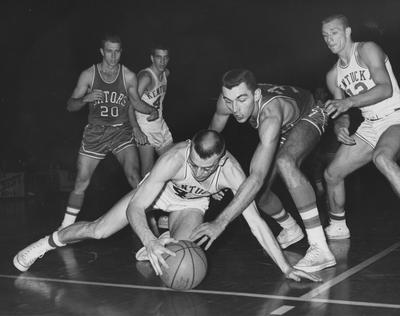 Basketball game action, UK versus Florida; Bill Lickert (44) and Allen Felhaus (12) watch as Roger Newman (42) dives for the ball; Public Relations photo