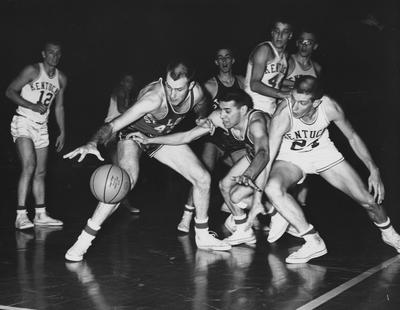 Basketball game action, UK versus St. Louis; UK players are (left to right) Allen Feldhaus, Jim McDonald, Bill Lickert, Roger Newman (with glasses), and Larry Pursiful