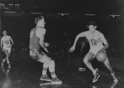 Basketball game action, UK versus Kansas; Bobby Watson (38) watches as Walt Hirsch (19) dribbles past defender; photo appears on page 190 in the 1951 Kentuckian