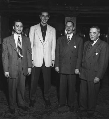 Alex Groza and three unidentified guests at party honoring coach Adolph Rupp and the basketball team