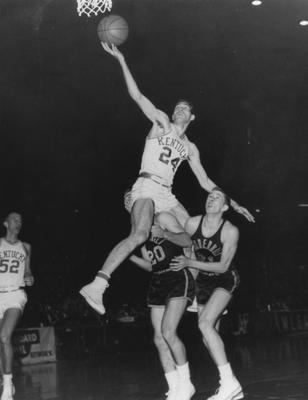 Basketball game action, UK versus Vanderbilt; Vernon Hatton (52) watches as Johnny Cox (24) shoots; photo appears in the 1957 Kentuckian, page 227; photographer:  Glenn Thomasson