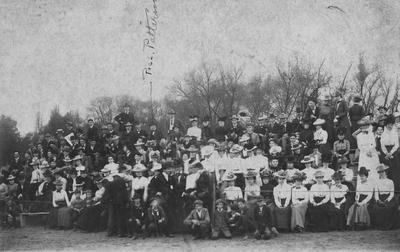Football game crowd at Kentucky State College; fans are seated on first wooden grandstand, designed and erected by the Engineering Department; President James K. Patterson can be seen on the back row of the grandstand, middle left