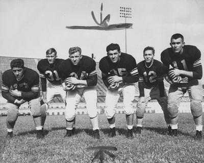 Members of UK football team before game against Cincinnati; pictured are (left to right) Tony Chiccino, Tommy Adkins, Allen Felch, Ralph Paolone, Jack Hanley, and Guy Tracey; AP photo. Received June 13, 1959 from Cincinnati Enquirer