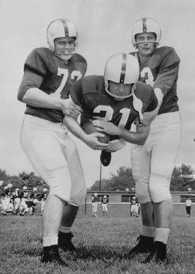 UK football team members Clyde Murrell (left), Ivan Curnutte (center, being held), and Tom Donlon. Received June 13, 1959 from Cincinnati Enquirer