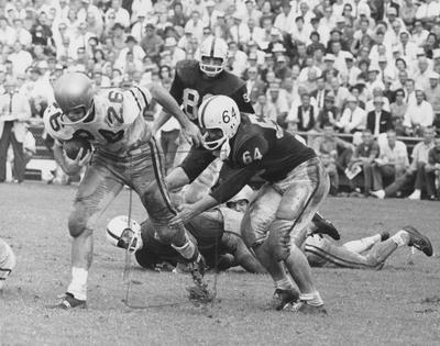 Unidentified football players during game against unidentified opponent; photographer:  Bill Diehl, Jr. and Associates. Received December of 1960 from Public Relations