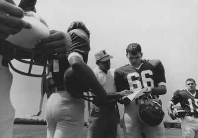 UK football head coach Charlie Bradshaw (1962-68) talking with an unidentified player; Public Relations photo