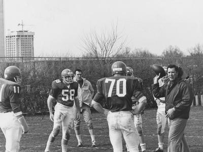 Unidentified UK football players during practice. Patterson Office Tower construction in the background. Photo appears on page 123 in the 1969 Kentuckian
