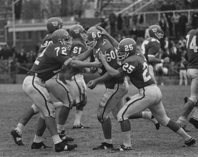 Unidentified football players during game against unidentified opponent. Photo appears on page 5 in the 1969 Kentuckian