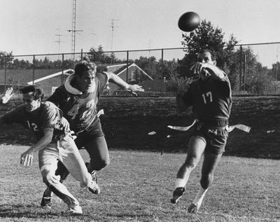 Unidentified men playing intramural football. Photo appears on page 216 in the 1969 Kentuckian