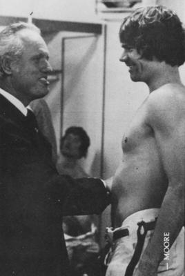 Kentucky Governor Julian Carroll with unidentified UK football player in locker room