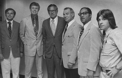 Athletics Association Board members; University Information Services photo.  From the left:  Chuck Ellinger, unidentified man, President Otis Singletary, unidentified man, Coach Roach (African - American) and an unidentified man