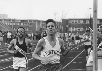 Bob Brewer, UK Track team member, running during meet; photo appears on page 124 in the 1969 Kentuckian