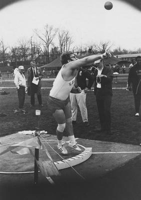 Unidentified member of UK Track team throwing shot put at meet, 1969; photo appears on page 125 in the 1969 Kentuckian