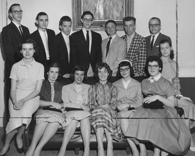 Hughetta Alica Bartlett (seated on arm of couch, far right), Ronald W. McCabe (standing far right), Lloyd R. Cress (3rd from right) and eleven unidentified individuals are all high school scholarship recipients