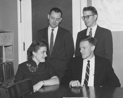 Four UK graduate students receive fellowships; pictured are Joy Neale Query, George Lester (seated), Robert Dowd (standing left) and Raymon Cravens, April 3, 1957; Public Relations photo