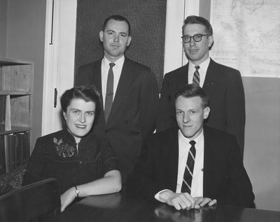 Four UK graduate students receive fellowships; pictured are Joy Neale Query, George Lester (seated), Robert Dowd (standing left) and Raymon Cravens, April 3, 1957; Public Relations photo