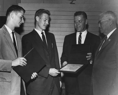 Two unidentified students (two on left), receiving an award, pictured with unidentified man in center and Dan Terrell, Dean of Engineering; Public Relations photo