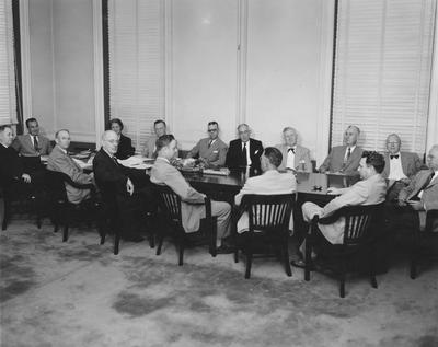 University of Kentucky Board of Trustees, 1952, in Administration Building boardroom including Governor Lawrence Weatherby and UK President Herman Donovan both seated at the far left end of the board table; other names of individuals listed on photograph sleeve