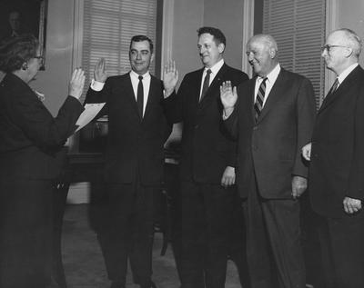 Esther McChesney swearing in new University of Kentucky Board of Trustees members; names of individuals listed on photograph sleeve; Lexington Herald-Leader photo, April 10, 1959