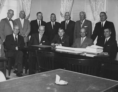 Kentucky Governor Bert Combs (seated at table, center, with hands on table) and eleven unidentified members of the Board of Trustees; Received December of 1960 from Public Relations photo