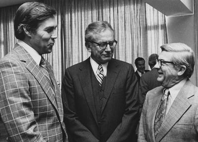 Pictured from left, Athletics Director Cliff Hagan, University President Otis Singletary, and Stanley Burlew (BOT, 1972-75) talking at a Board meeting