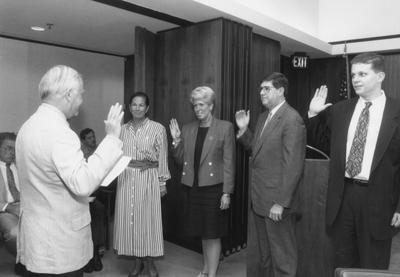 New University of Kentucky Board of Trustees members are sworn in; pictured from left, Kay Shropshire Bell (alumni representative), Marian Moore Sims, Frank C. Shoop, and Scott Crosbie (SGA President)