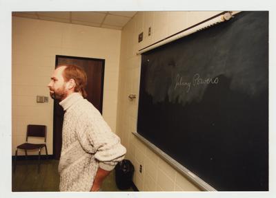 A male professor lectures in a classroom