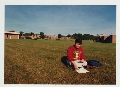 A male student studies outside