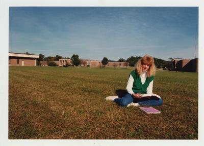 A female student studies outside