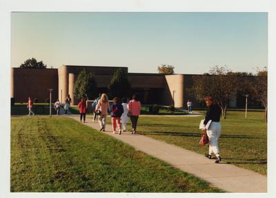 Students walk towards the Richard Ernest Cooper Academic / Technical Building