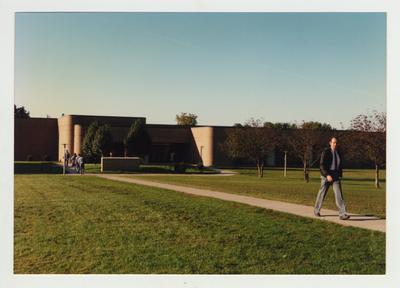 Students walk towards the Richard Ernest Cooper Academic / Technical Building