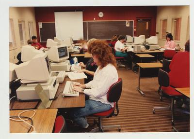 Students type on computers in a classroom