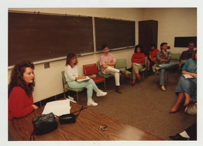 Students listen to a female student speaking